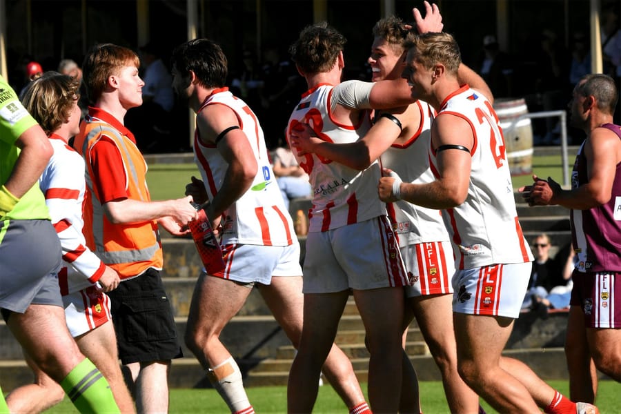 An Australian Rules contest in front of a full stand